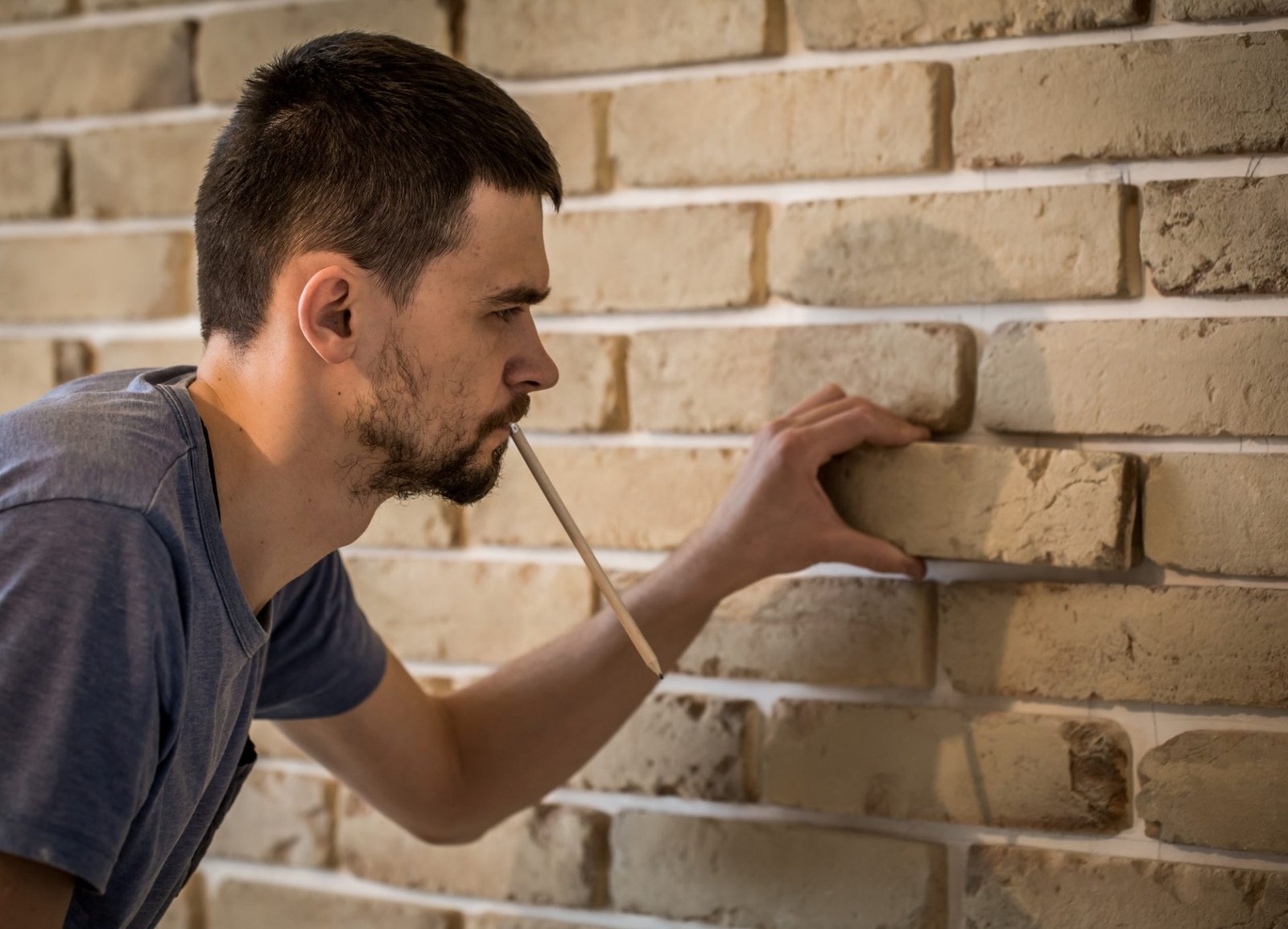 male works with brick wall with centimeter
