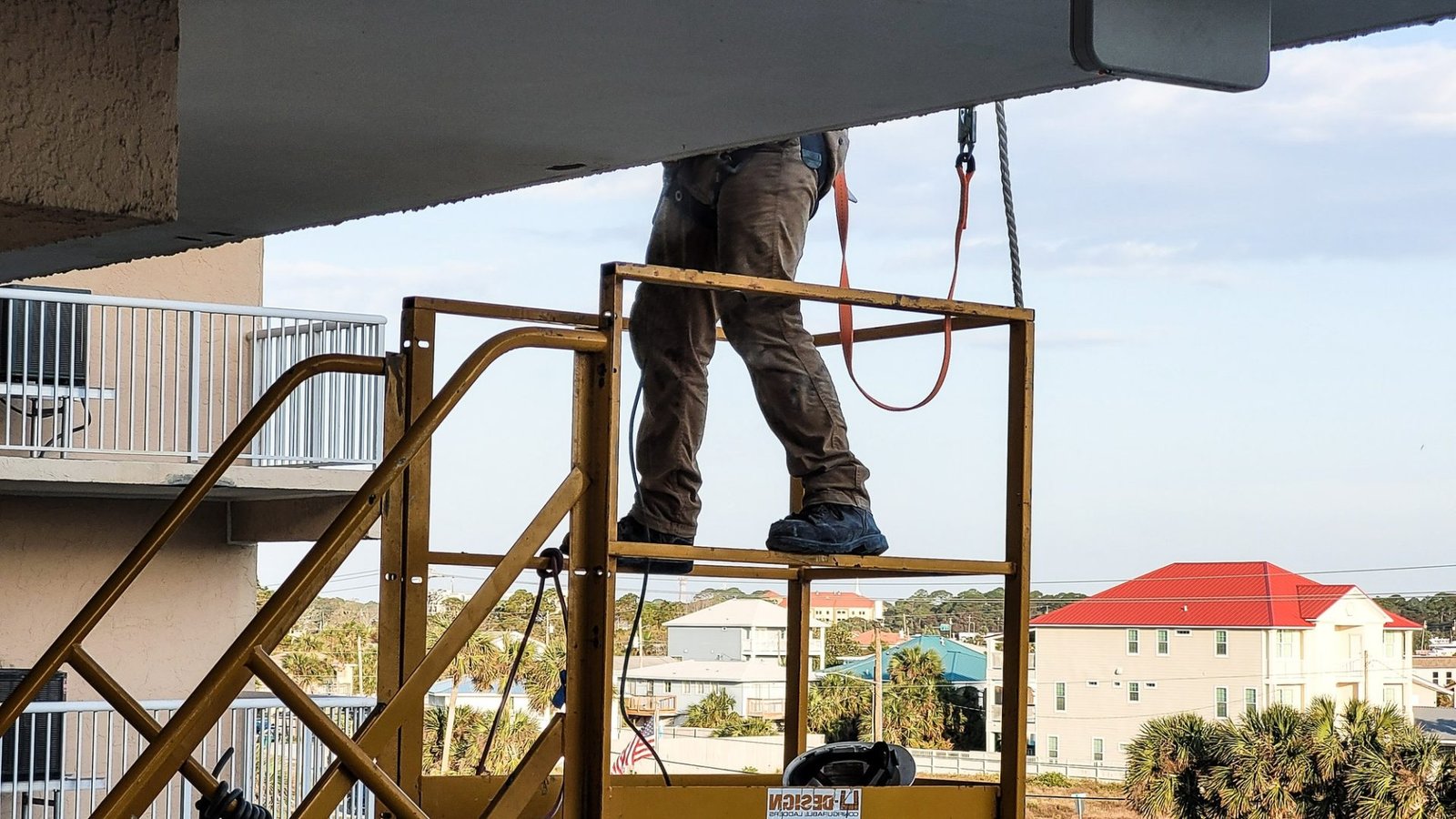 Working on the condo building outside patchwork before painting begins.