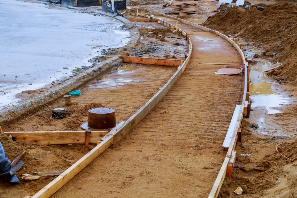 Sidewalk under construction, concrete curb installation in progress