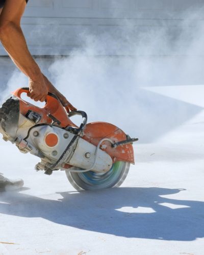 Precise Concrete Paving Removal by Construction Worker Using Diamond Blade Saw